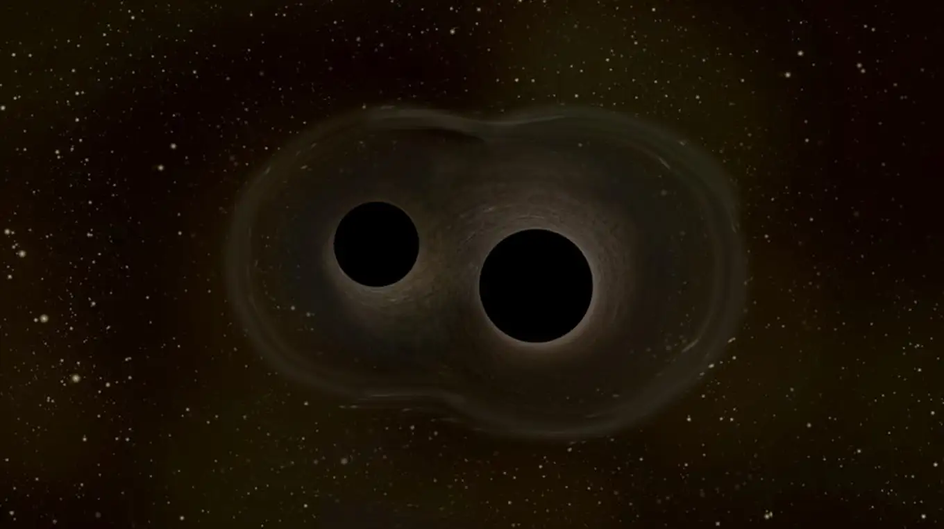 Representación de dos agujeros negros fusionándose y emitiendo ondas gravitacionales